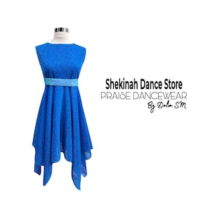 May include: A blue dance dress with a shimmering fabric, featuring a scoop neckline and a flowing, asymmetrical hemline. A light blue embellished belt accents the waist. The text "Shekinah Dance Store PRAISE DANCEWEAR By Dalia SM" is visible.