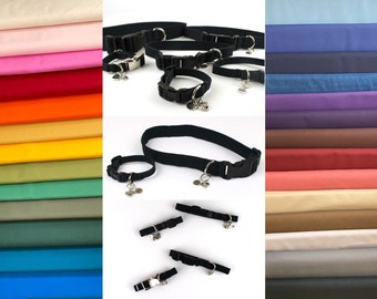 May include: Black dog collars with silver-tone hardware and a small charm. The collars are displayed in various sizes, with a black plastic buckle closure. A variety of colorful fabric swatches are shown in the background.