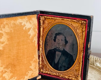 Antique TinType Photo in Leather Embossed Book with Latch, Male with Bowtie, Ambrotype, 2.75"