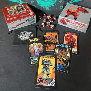May include: A Head Lopper custom dice set featuring a red and white box, a black drawstring bag with a white graphic, and several multi-colored polyhedral dice. Five illustrated character cards labeled Norgal, Twerpal, Agatha, Zhaania, and Berserkr are displayed alongside the game components.