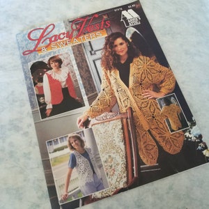 May include: A magazine cover featuring crochet vests and sweaters. The cover features three women wearing different crochet garments. The magazine is titled "Lacy Vests & Sweaters" and is published by Annie's Attic.