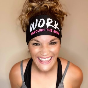 May include: Black headband with white text that reads "WORK THROUGH THE BURN" in a handwritten style. The text is in a white font with a pink outline.