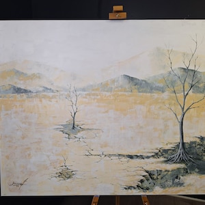 May include: A painting of a cracked, dry landscape with two bare trees. The background is a hazy, pale blue with distant mountains. The trees are silhouetted against the sky, and the ground is a pale yellow with cracks running through it.