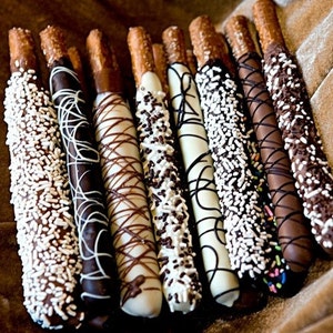 Chocolate Covered Pretzels! Decorated in white, milk and dark chocolate with sprinkles and beautiful drizzle!  Perfect wedding favor!