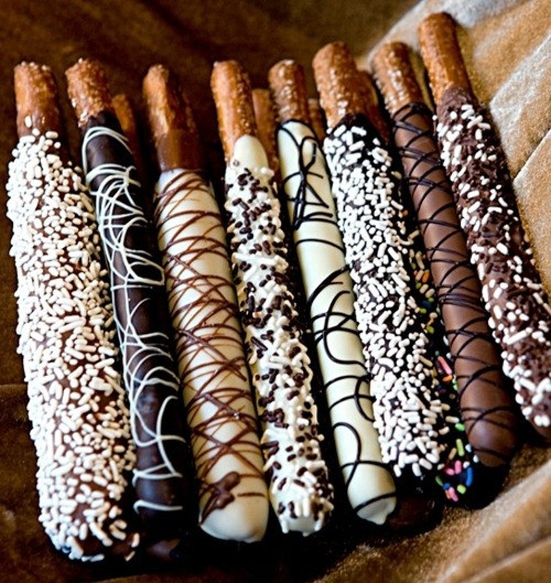 Chocolate Covered Pretzels! Decorated in white, milk and dark chocolate with sprinkles and beautiful drizzle!  Perfect wedding favor!