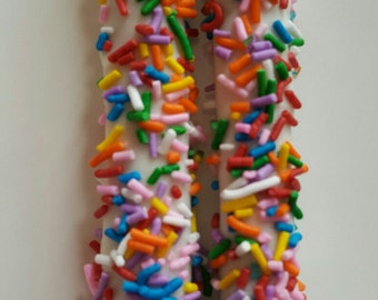 White chocolate covered pretzels with rainbow sprinkle decor!  Perfect for Circus or Carnival Themed Birthday Party or Event!