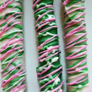 Chocolate Covered Pretzels! Decorated in white chocolate with beautiful pink and green design!  Perfect birthday treat or party favor!
