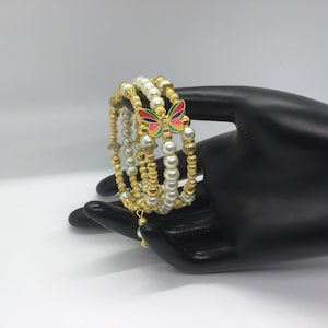 Stunning Pearl and Gold memory wire coil bracelet with Butterfly bead as focal point
