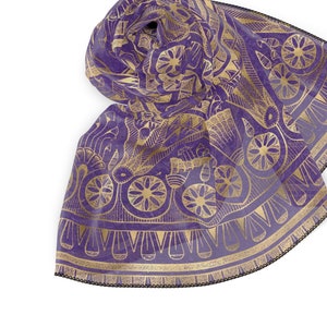 May include: A purple silk scarf with a gold geometric pattern. The scarf has a fringed edge.