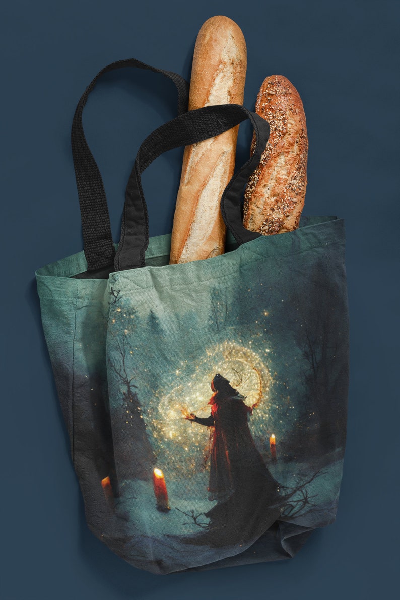 May include: A blue tote bag featuring a magical forest scene print. The bag is filled with two loaves of bread, one white and one with seeds.