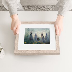 May include: Framed print of a painting depicting five figures in white robes standing in a misty forest setting. The figures are holding flowers and appear to be engaged in a ritual or ceremony.