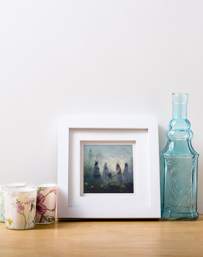 May include: A white picture frame with a mat and a print of a painting of three figures in a forest setting. The figures are wearing white robes and have flowers in their hands. The background is a soft blue and green.