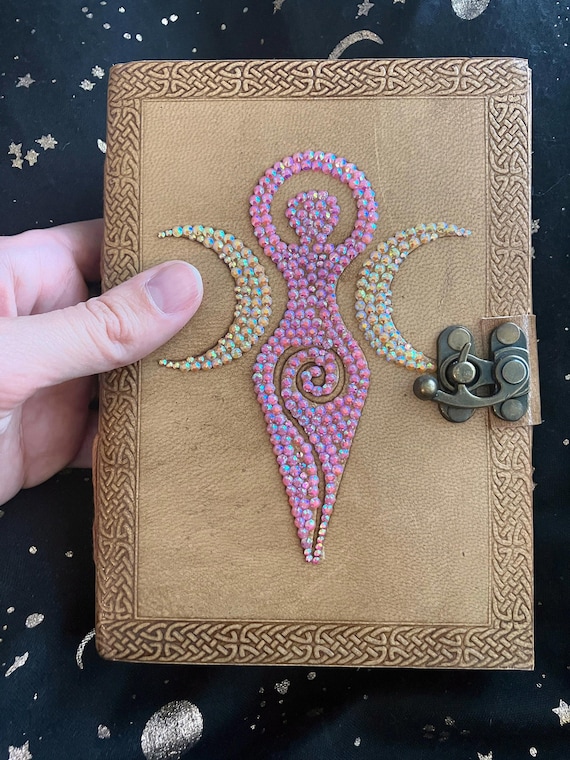 Hand-decorated leather Book of Shadows with an Earth & Moon Goddess theme — the kind of journal that feels like a prop from a beloved fantasy film.