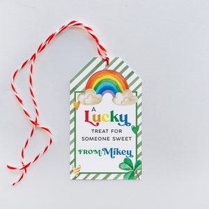 May include: A green and white striped gift tag with a rainbow, clouds, and shamrocks. The tag says "A Lucky Treat for Someone Sweet From: Mikey".
