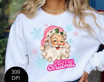 May include: White sweatshirt with a pink and white vintage Santa Claus illustration and the text "Merry Christmas" in pink. The Santa Claus is wearing a pink hat with holly and a white beard.