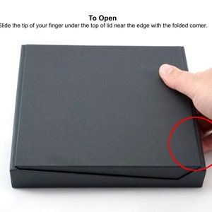 Slide the tip of your finger under the lid near the edge with the folded corner to open.