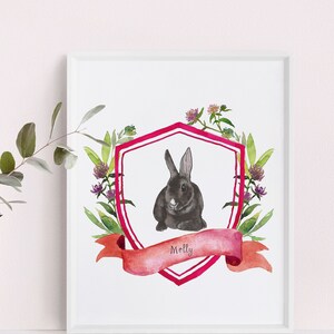 May include: A watercolour illustration of a black rabbit in a pink and white shield with a pink ribbon that says "Molly". The shield is surrounded by green leaves and pink flowers.