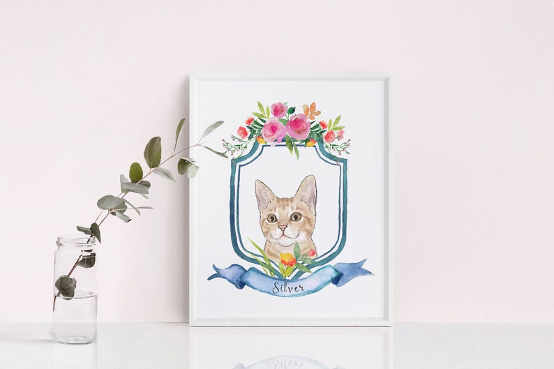May include: A watercolour painting of a cat with a blue and white shield and a floral wreath. The cat is looking at the viewer and has a name tag that says "Silver".