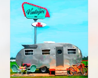 May include: A vintage silver camper trailer parked at The Vintages Trailer Resort RV Park. The camper has a wooden step and two bicycles are parked next to it. Two turquoise chairs and a small table with a bottle of wine and glasses are in front of the camper.