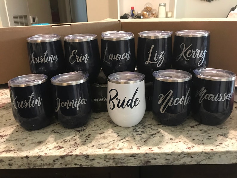 May include: Set of ten stainless steel wine tumblers with personalized names, including "Bride", "Kristin", "Jennifer", "Christina", "Erin", "Lauren", "Liz", "Kerry", "Nicole", and "Marissa".