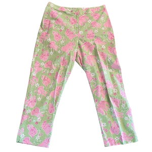 May include: Green pants with a pink floral pattern featuring pink bunnies.