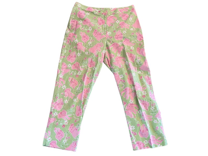 May include: Green pants with a pink floral pattern featuring pink bunnies.