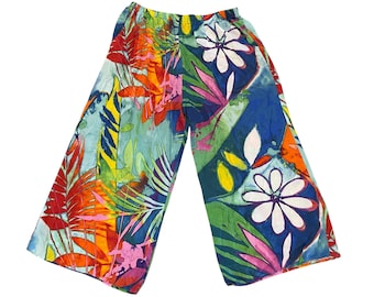 May include: Colorful wide-leg pants with a tropical print featuring large flowers and leaves in shades of red, orange, yellow, green, blue, and white.