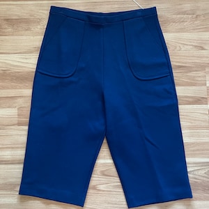 May include: A pair of dark blue, high-waisted shorts with two large patch pockets on the front.