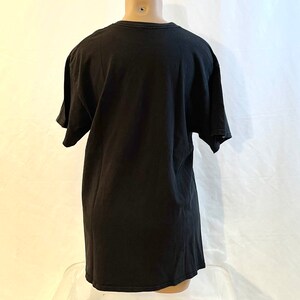 May include: A black short-sleeved t-shirt.