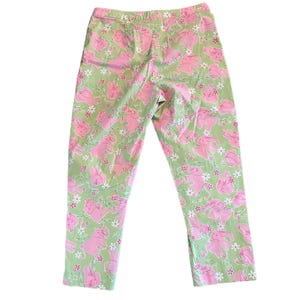 May include: Green pants with a pink bunny rabbit print.