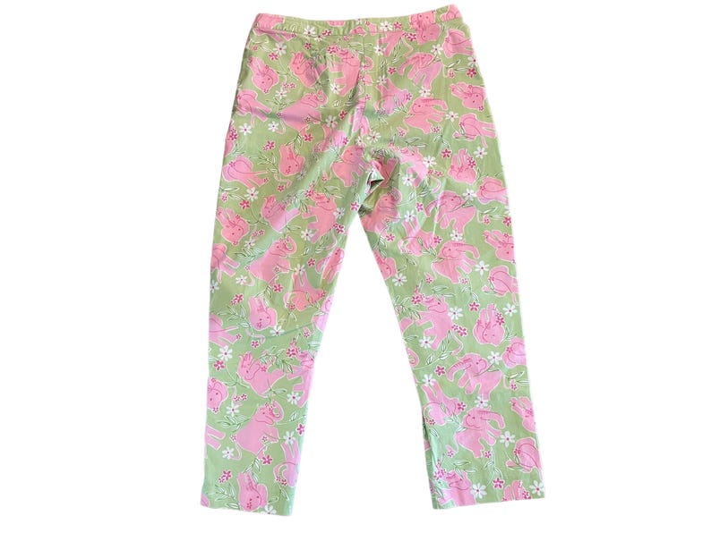May include: Green pants with a pink bunny rabbit print.