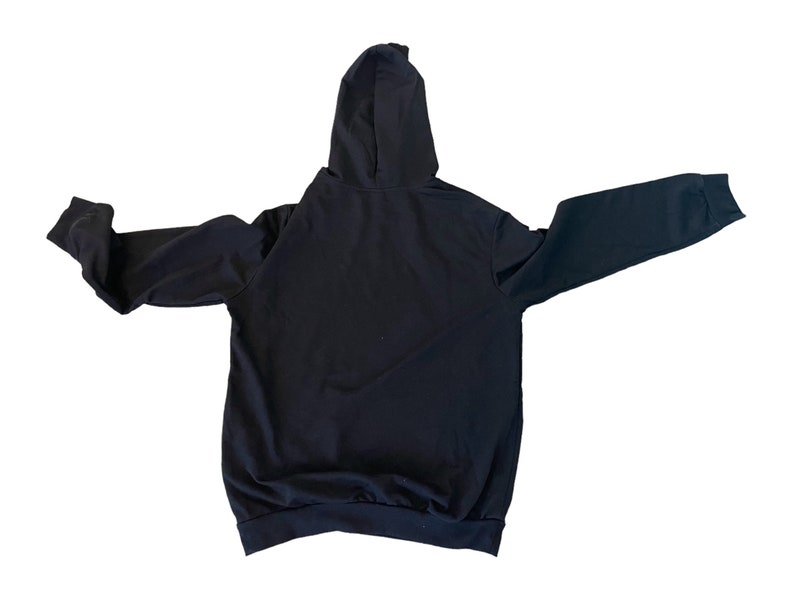 May include: A black hooded sweatshirt with long sleeves and a pouch pocket. The sweatshirt is made of a soft, comfortable fabric.