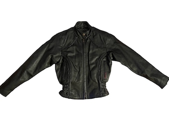 May include: Black leather motorcycle jacket with a stand-up collar and a zipper closure. The jacket features braided detailing on the shoulders, sleeves, and sides, with pockets and a cinched waist. The jacket is displayed on a white background.