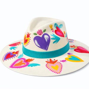 Hand painted heart fedora hat made in Mexico with colorful heart designs displayed on white background