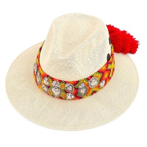 Mexican artisan wide brim straw sun hat with sacred heart charms, red tassel, and colorful knitted band
