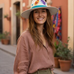 Woman wearing a Bootsologie hand painted heart fedora hat made in Mexico styled for boho outfit