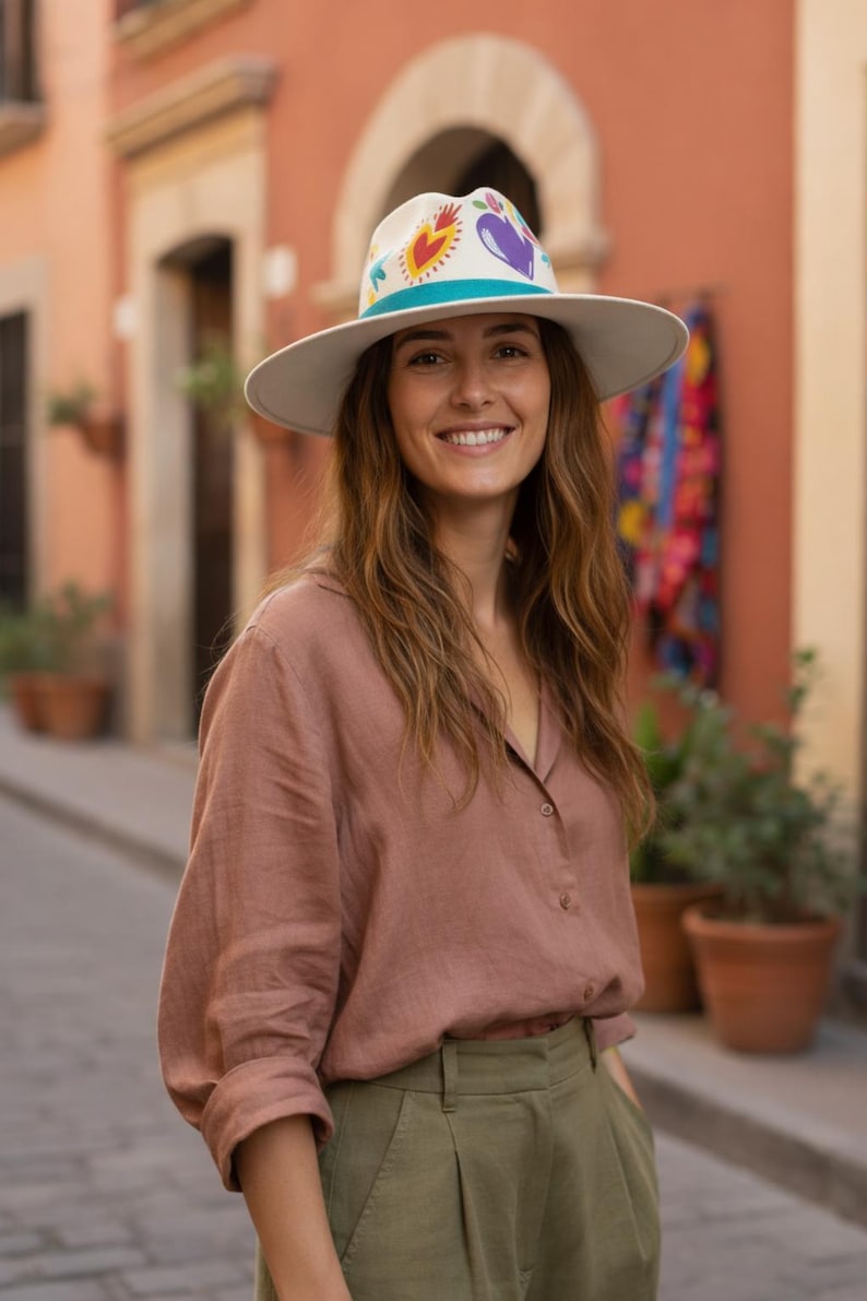Woman wearing a Bootsologie hand painted heart fedora hat made in Mexico styled for boho outfit