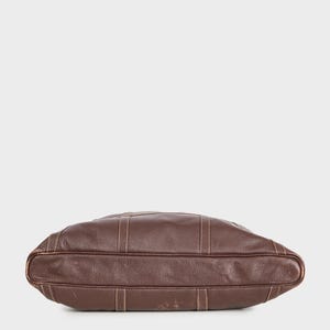 May include: A brown leather tote bag with a stitched design. The bag is shown from the bottom.