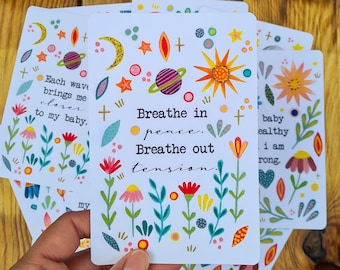 May include: A white card with colorful flowers and a quote that reads "Breathe in peace. Breathe out tension." The card is part of a set of cards with different quotes and designs.