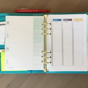 May include: A turquoise blue planner with a gold ring binder. The planner has a weekly layout with sections for Monday, Tuesday, and Wednesday. The planner has a section for notes and a pocket for storing papers.