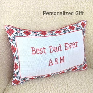 May include: White rectangular pillow with red embroidered text that reads "Best Dad Ever A & M". The pillow has a red and black geometric border and the words "Personalized Gift" at the top.