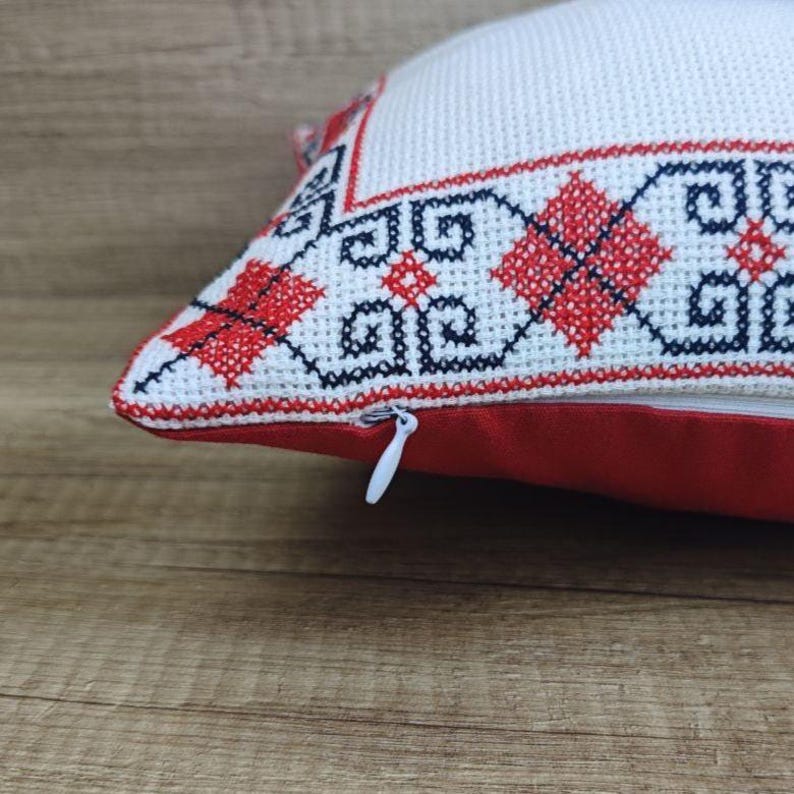 Detailed shot of the high-quality zipper closure on a square red black personalized decorative pillow cover, showing durable craftsmanship.