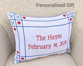 May include: White decorative pillow with blue grid lines, red hearts, and the text "The Hayes February 14, 2026". The pillow has a personalized gift theme.