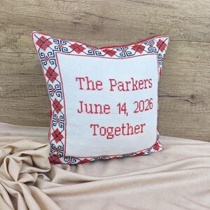 An elegant side-view of the artisan square red black personalized decorative pillow cover on a cashmere blanket, perfect for high-end home decor or a luxury gift.