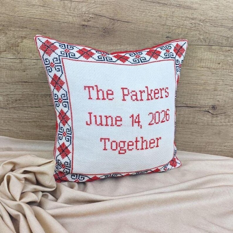 An elegant side-view of the artisan square red black personalized decorative pillow cover on a cashmere blanket, perfect for high-end home decor or a luxury gift.