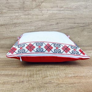Side-profile image of the square red black personalized decorative pillow cover, showing its full-bodied shape and durable construction.