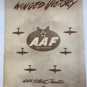 May include: Vintage program cover for "Winged Victory" featuring brown text and airplane silhouettes on a beige background. The AAF logo is centered, surrounded by planes. The text "44th Street Theatre" is at the bottom.