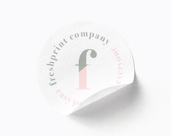 May include: White round sticker with the text "freshprint company everyone easy print" in a circle around a pink and gray letter "F" in the center.