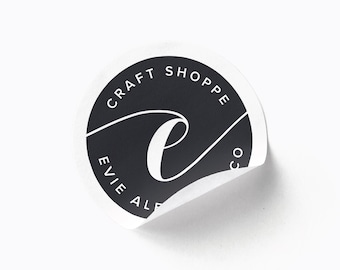 May include: Black and white sticker with the text "Craft Shoppe Evie Ale Co."