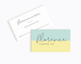 May include: A business card with the text "florence aurora" and the website address "florenceaurora.com". The card is white with black text. A second business card is shown with a light blue and yellow background. The text "florence AURORA CO." is in black on the card.